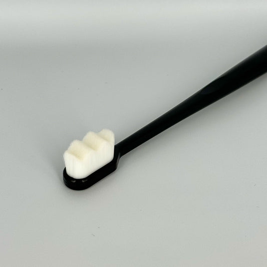 Watch cleaning brush with soft white bristles, close-up – Artisan Watch Co.