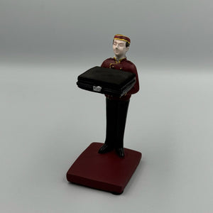 Maroon bellboy figurine watch holder holding a briefcase tray – Artisan Watch Co.