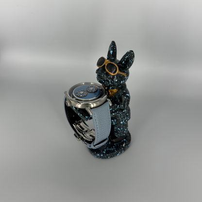 Galaxy Dog figurine watch holder with blue splatter finish and gold aviators, displaying a watch on its arm – Artisan Watch Co.